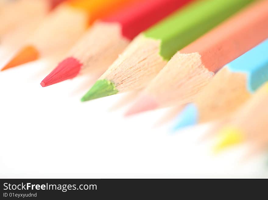 Macro pencil group pointing bottom left landscape on white background