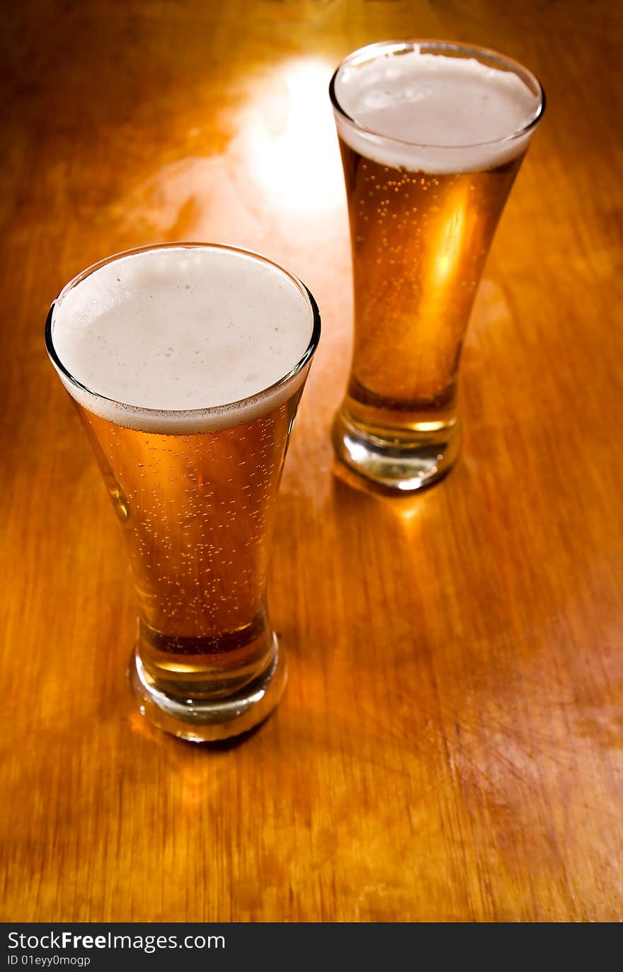 Beer glasses on wood background, selective focus. Beer glasses on wood background, selective focus