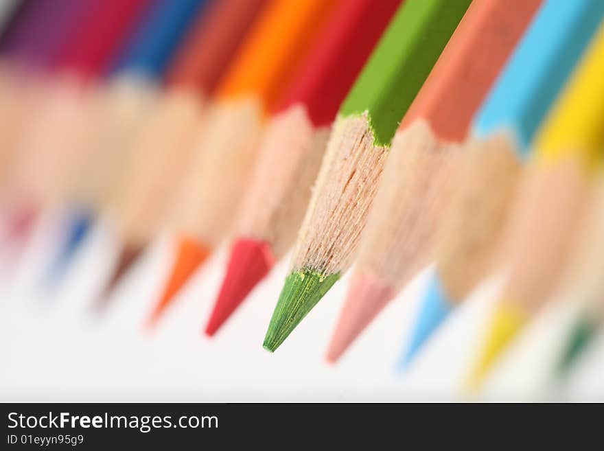 Macro pencil group pointing down landscape on white background