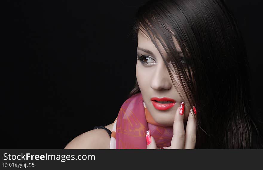 Beautiful brunet woman in red scarf at black background. Beautiful brunet woman in red scarf at black background