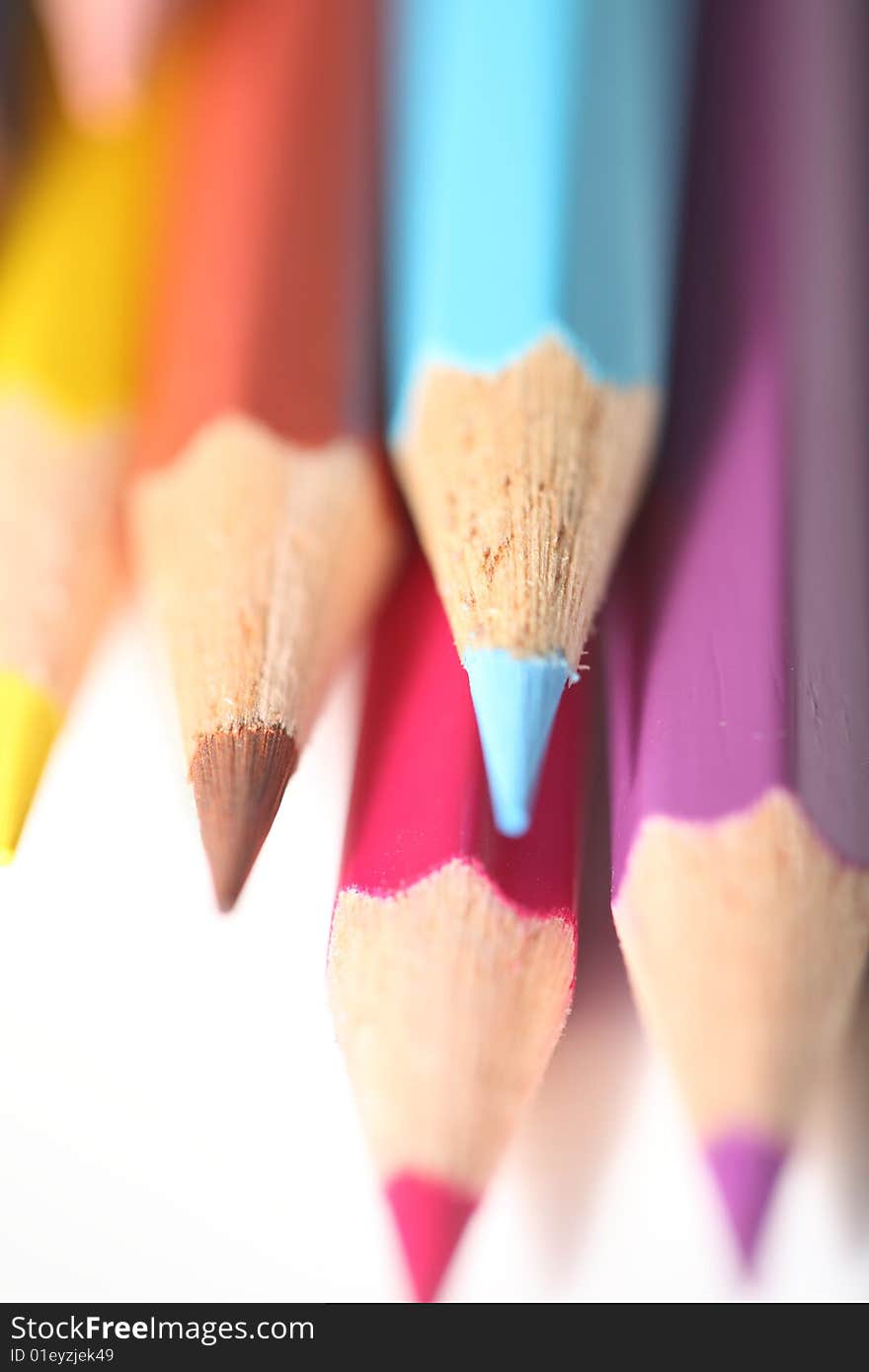 Macro pencil cluster down blue focus on white background. Macro pencil cluster down blue focus on white background