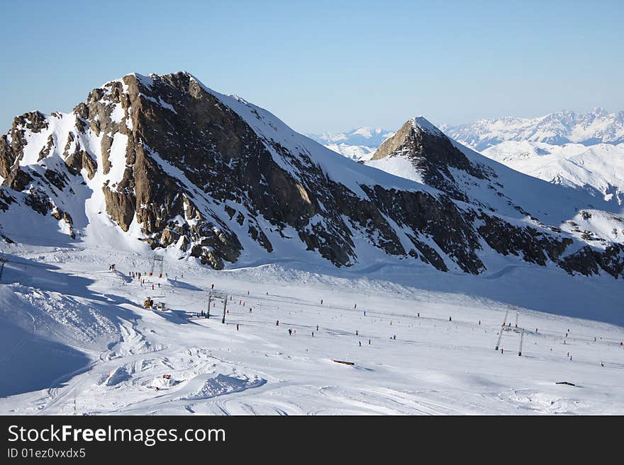 Austria. Mountains. The Alpes, the lift for mountain skiers.Snow and the bright dark blue sky. Austria. Mountains. The Alpes, the lift for mountain skiers.Snow and the bright dark blue sky.