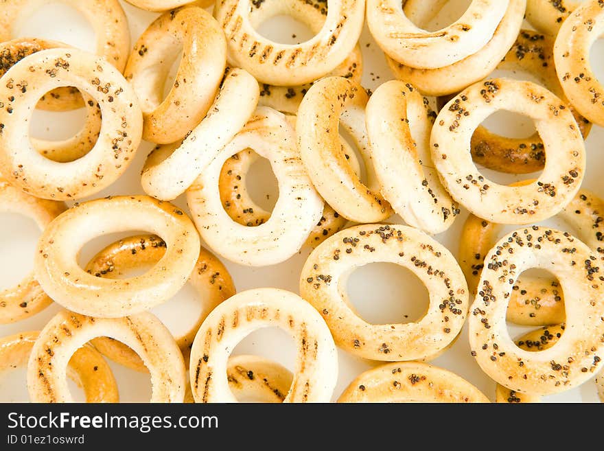 Bread-rings with poppyseeds on white ground