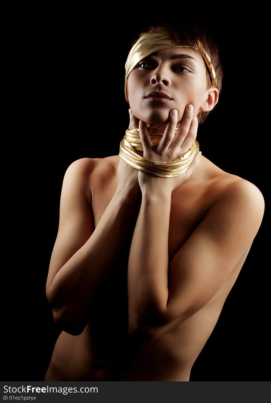 Glamour Man with Gold Bandage. Isolated on Black Background