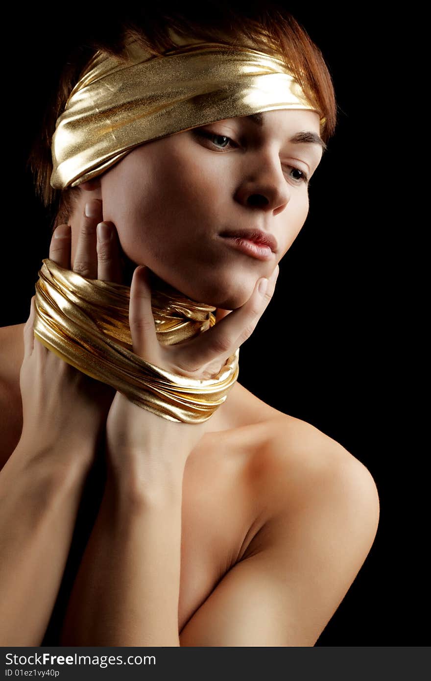 Blue-Eyed Glamour Man with Gold Bandage. Isolated on Black Background