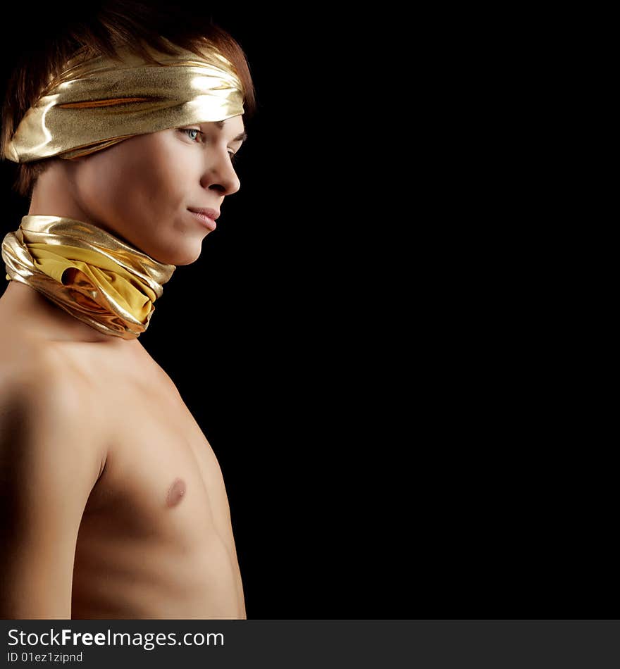 Glamour Man with Gold Bandage. Isolated on Black Background