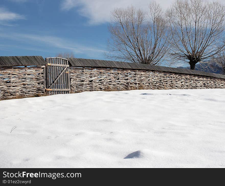 Winter scenery with woven wood fence in high country. Winter scenery with woven wood fence in high country