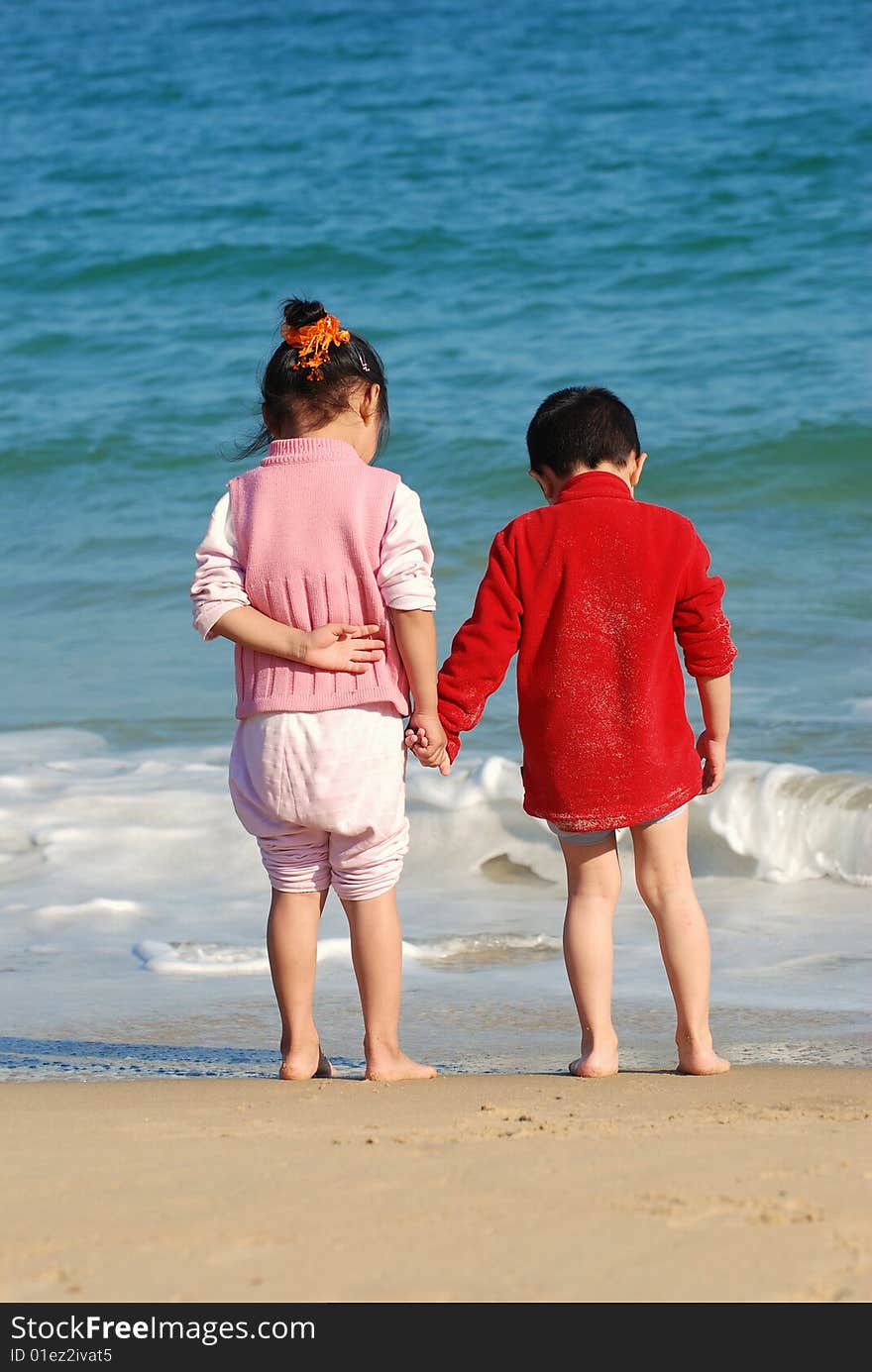 Young Kids Playing in the surfy beach