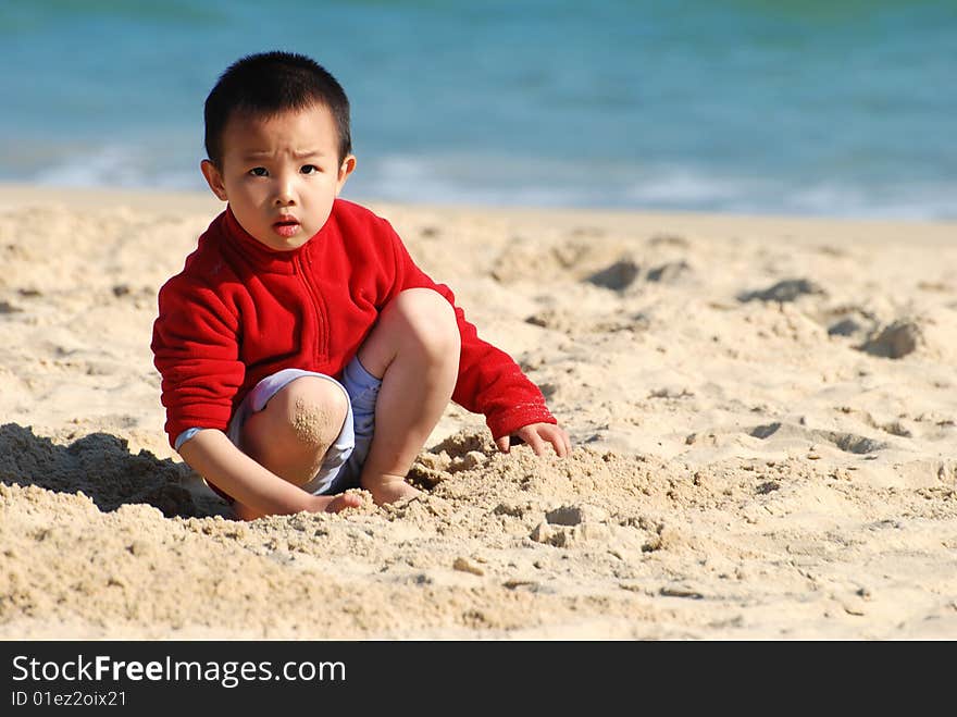 Young Boy Playing in sunny beach. Young Boy Playing in sunny beach