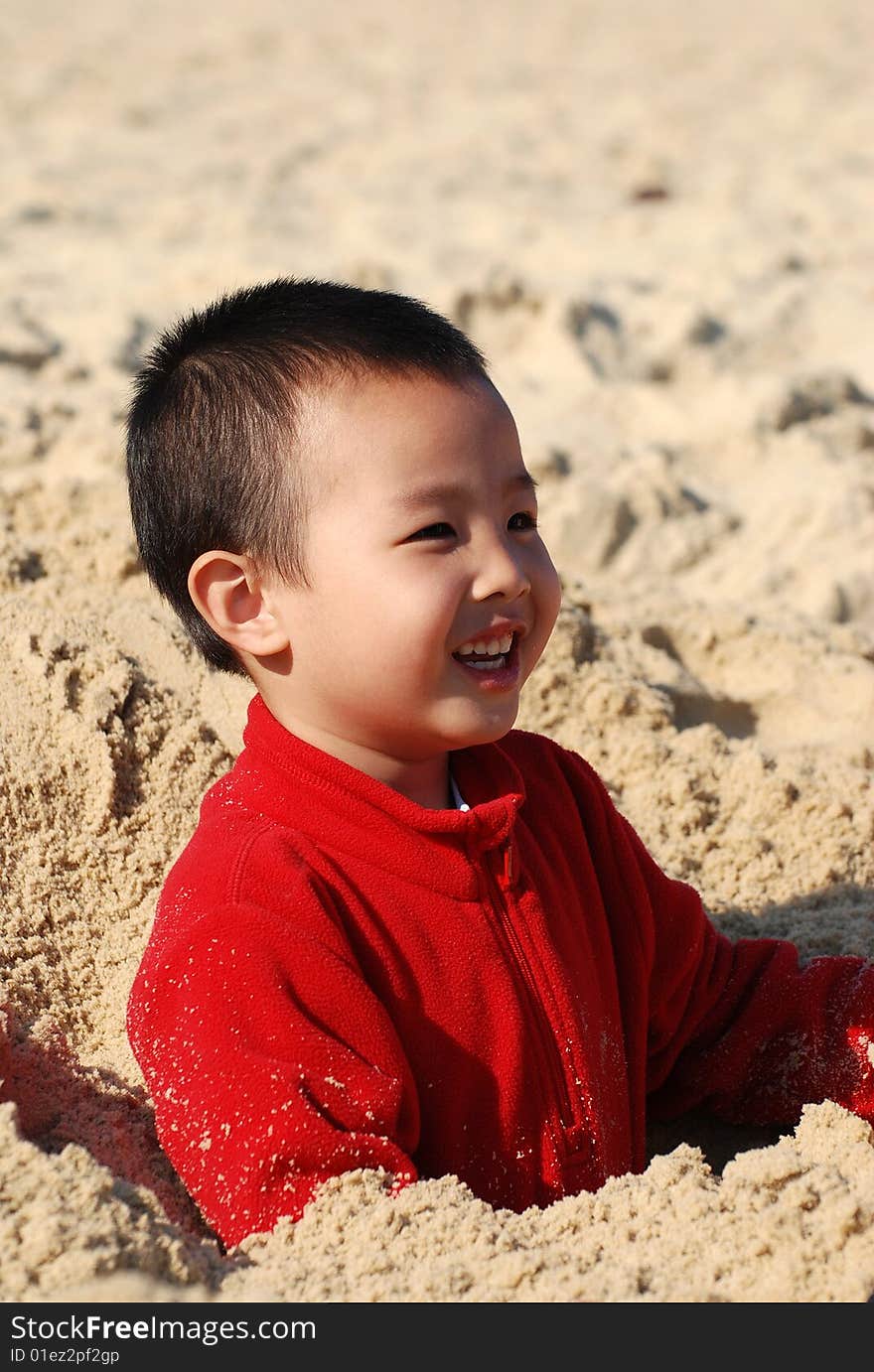 Young Boy Playing in the sunny beach. Young Boy Playing in the sunny beach