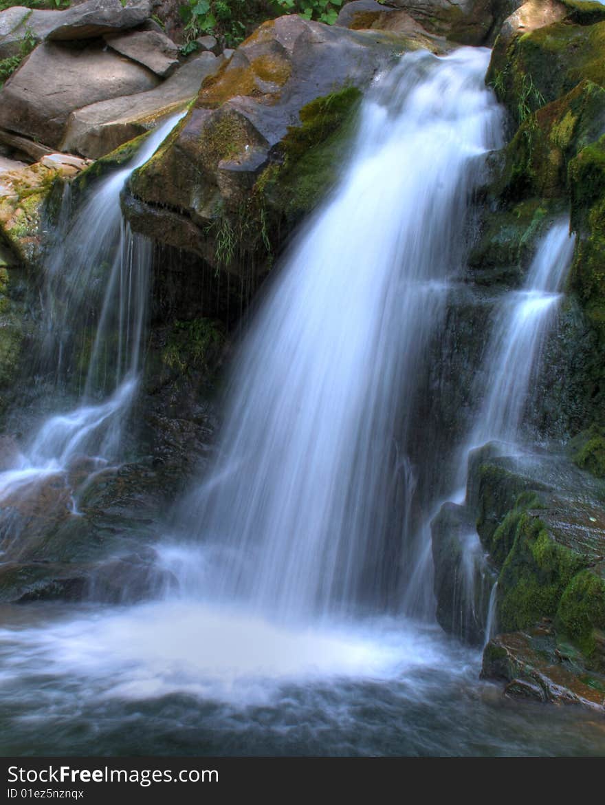 On a photo mountain river, stone with moss. Ukraine, Karpaty