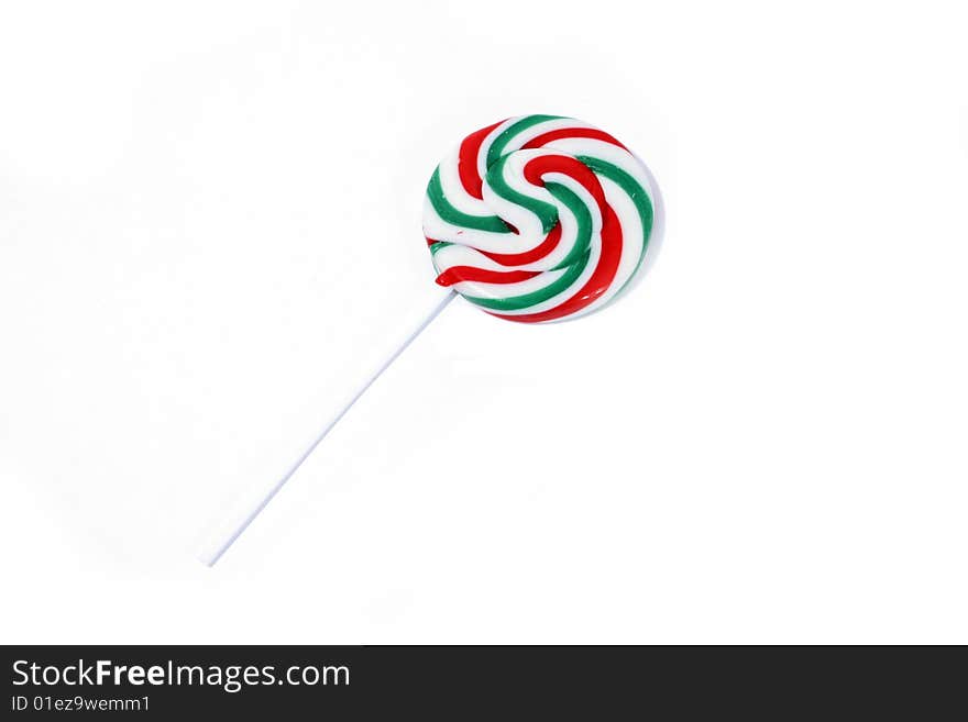 One single handmade lollipop on a white background. One single handmade lollipop on a white background.