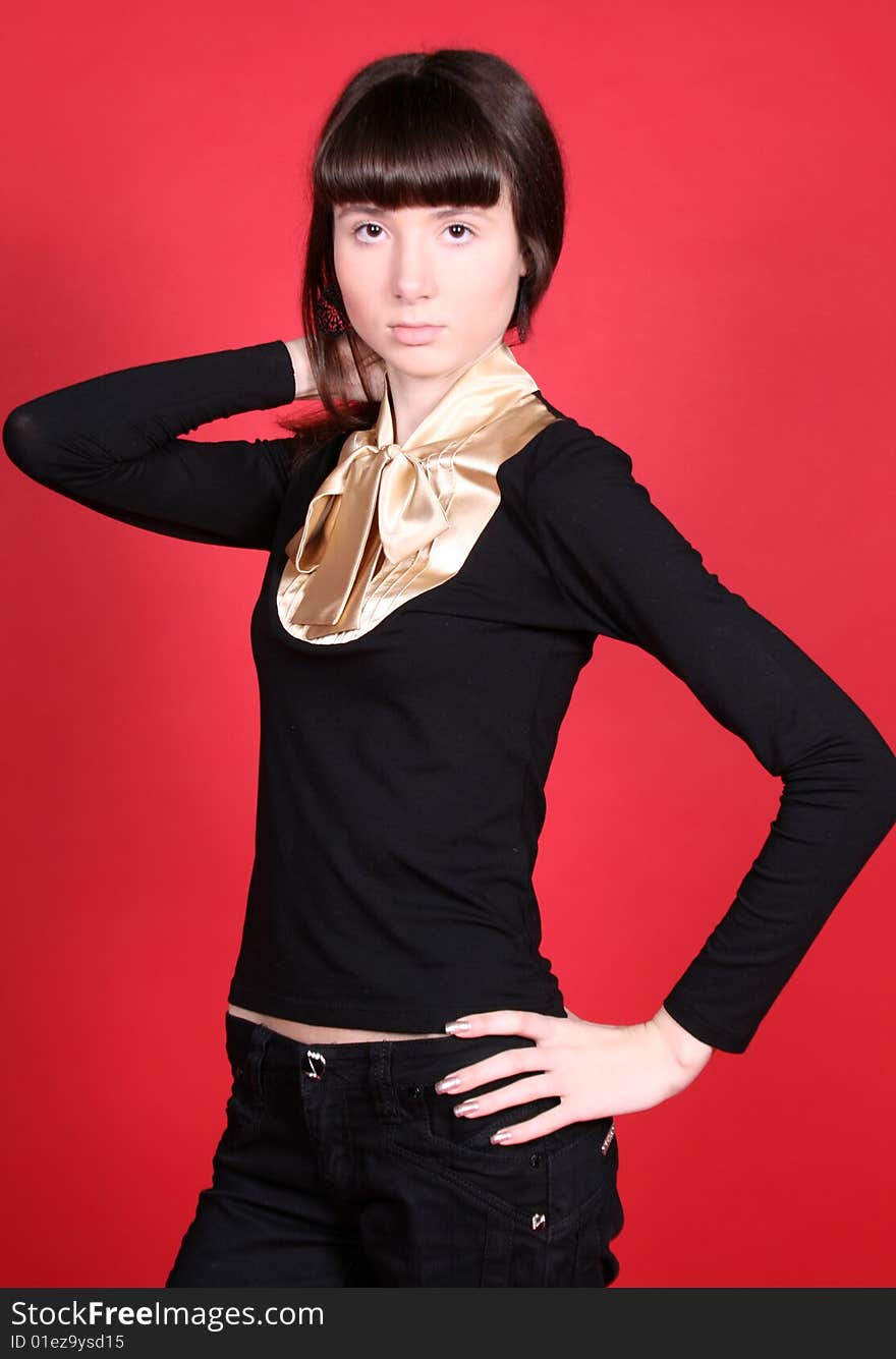 A studio portrait of a standing girl. A studio portrait of a standing girl