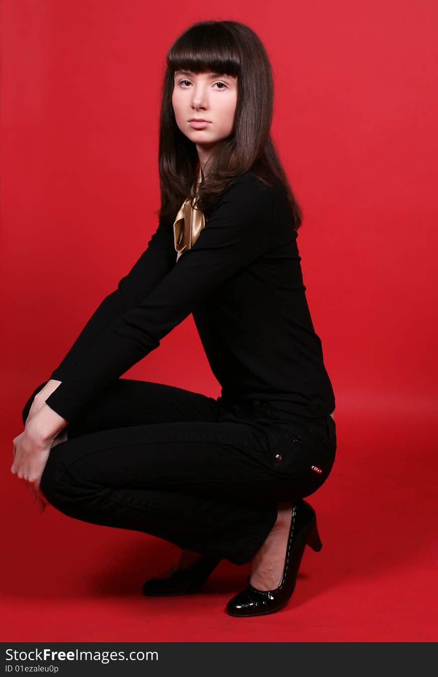 A girl squating in studio