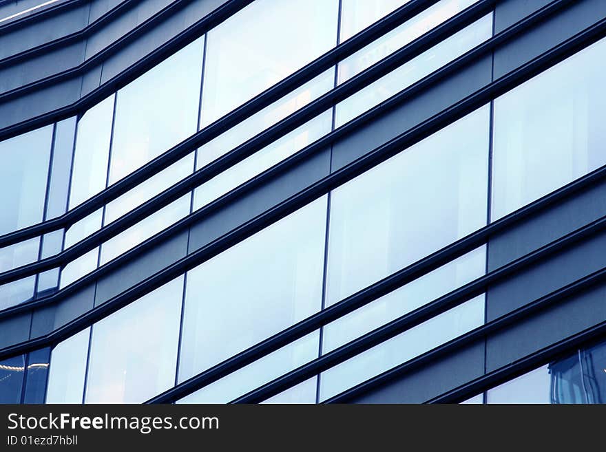 Side detail of corporate building windows with reflections