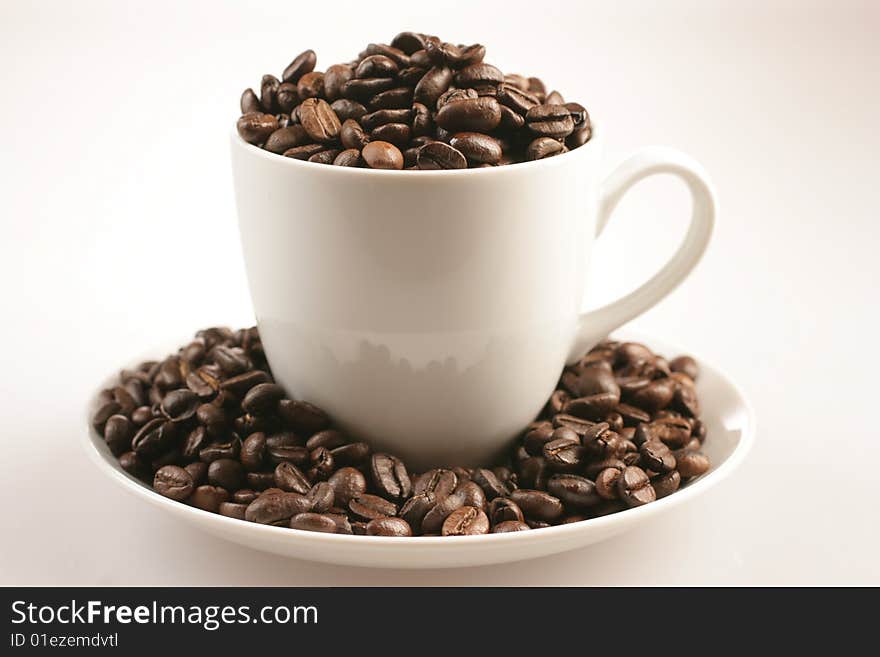 Coffee cup and beans on white bacground