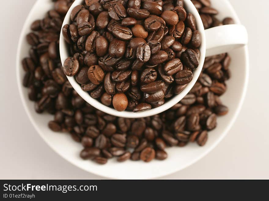 Coffee cup and beans on white background