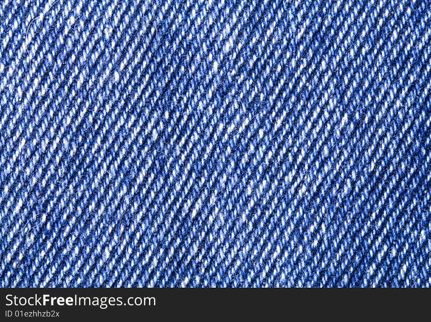 A close-up of the texture of blue jeans fabric. A close-up of the texture of blue jeans fabric