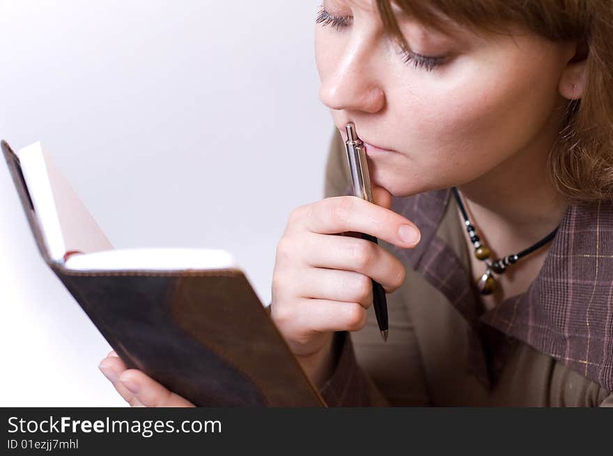 Female reading notes in notebook