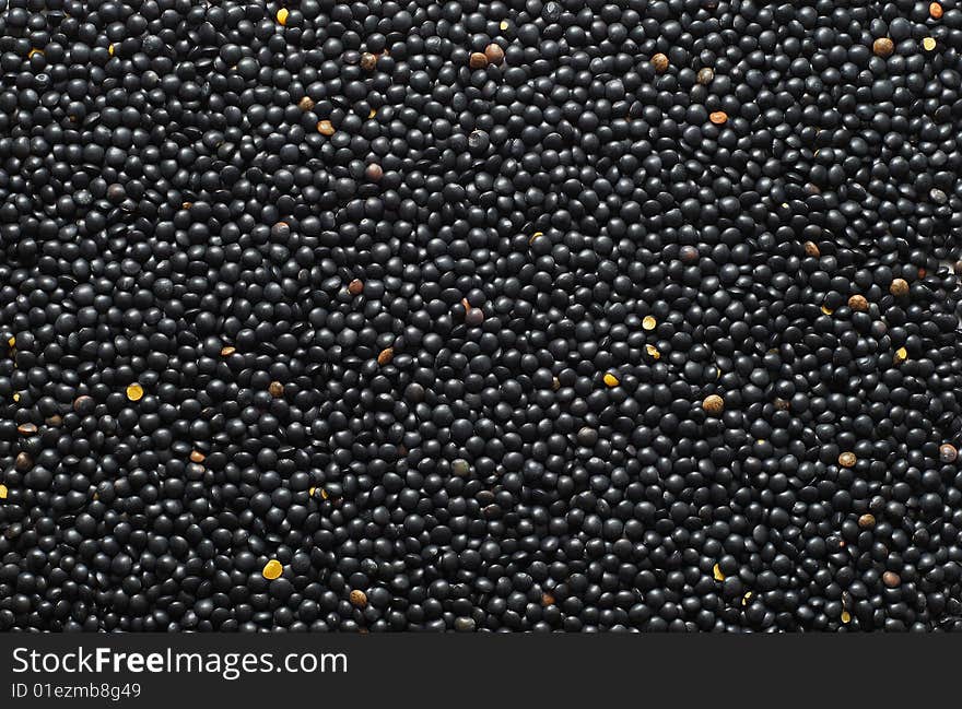 Black lentil background. food background