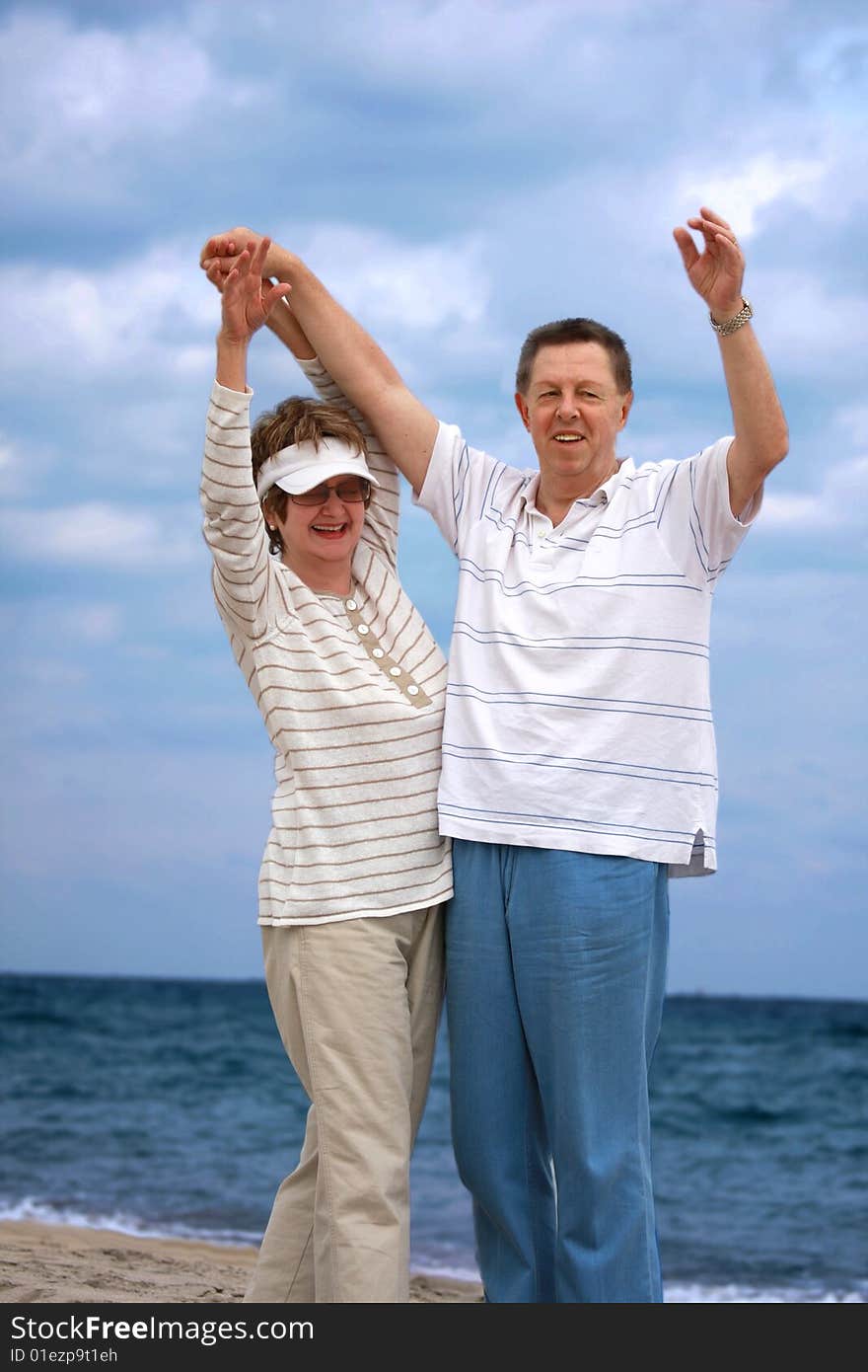 Romantic mature couple having fun   at the beach