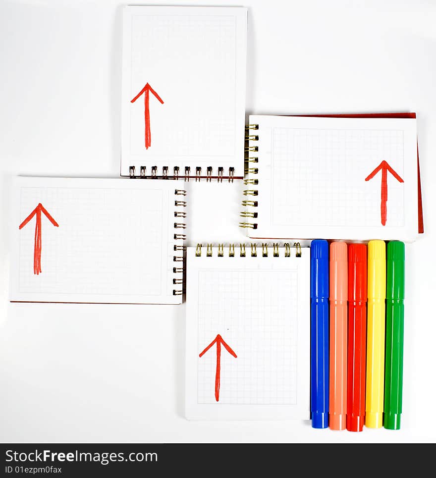 Four open notebooks with arrows and colors felt-tip pens. Four open notebooks with arrows and colors felt-tip pens