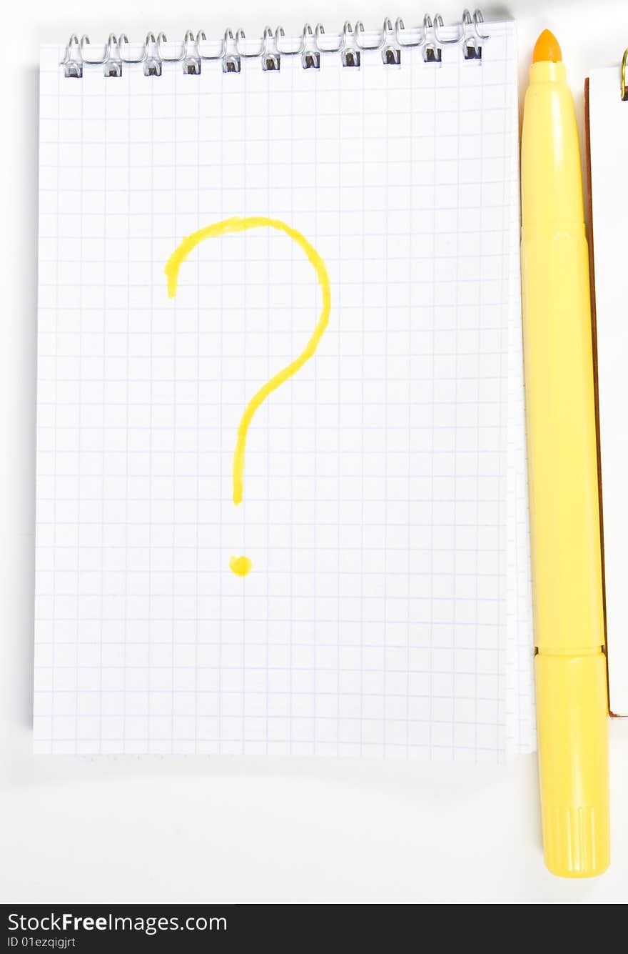 One open notebook with inscription and yellow felt-tip pen