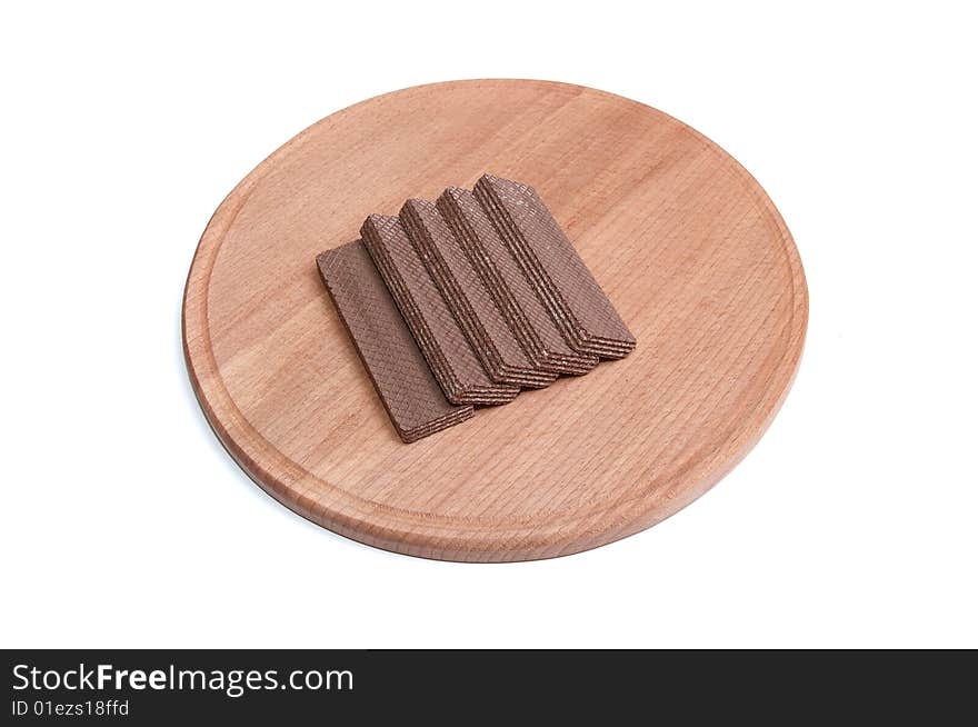 Brown wafers at the round desk isolated on a white background. Brown wafers at the round desk isolated on a white background.