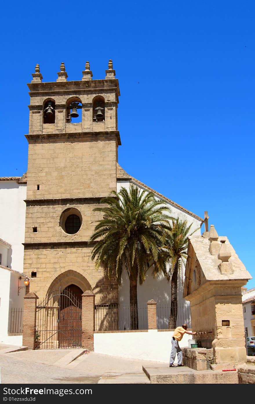 A Spanish church with its fountain in a small picuresque Spanish village