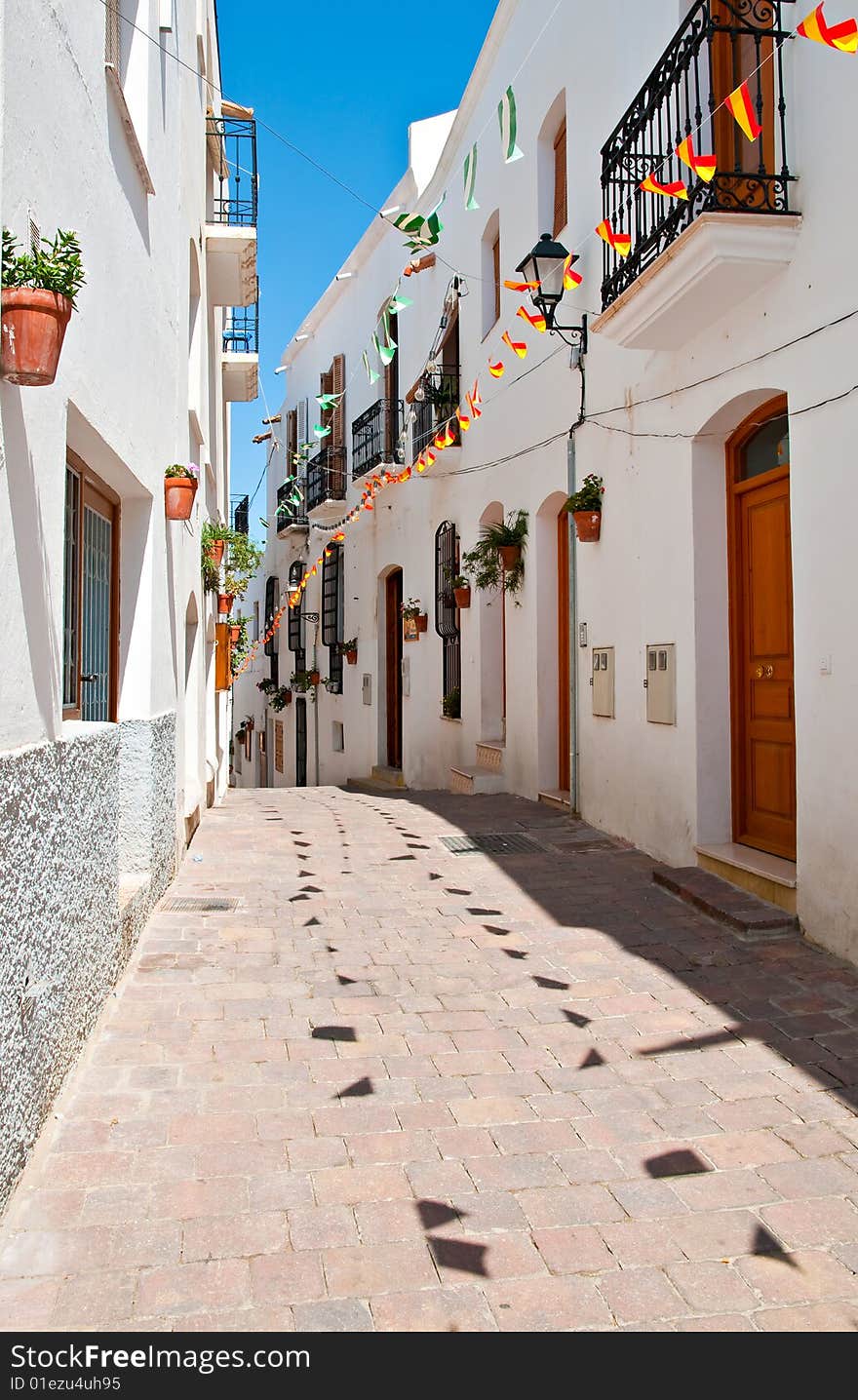 A quiet cobbled street in a small Spanish village. A quiet cobbled street in a small Spanish village.