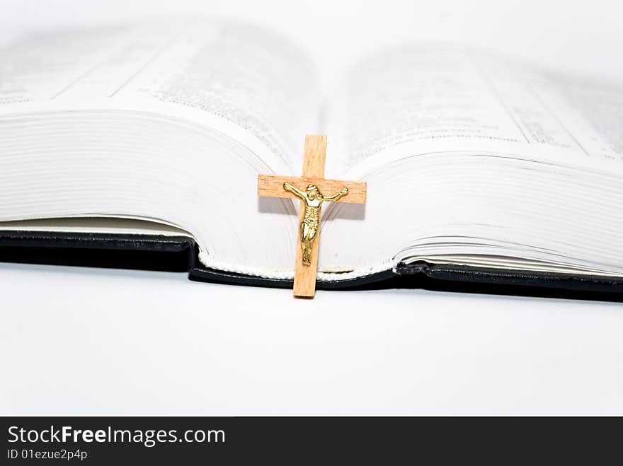 Book and cross on the white background