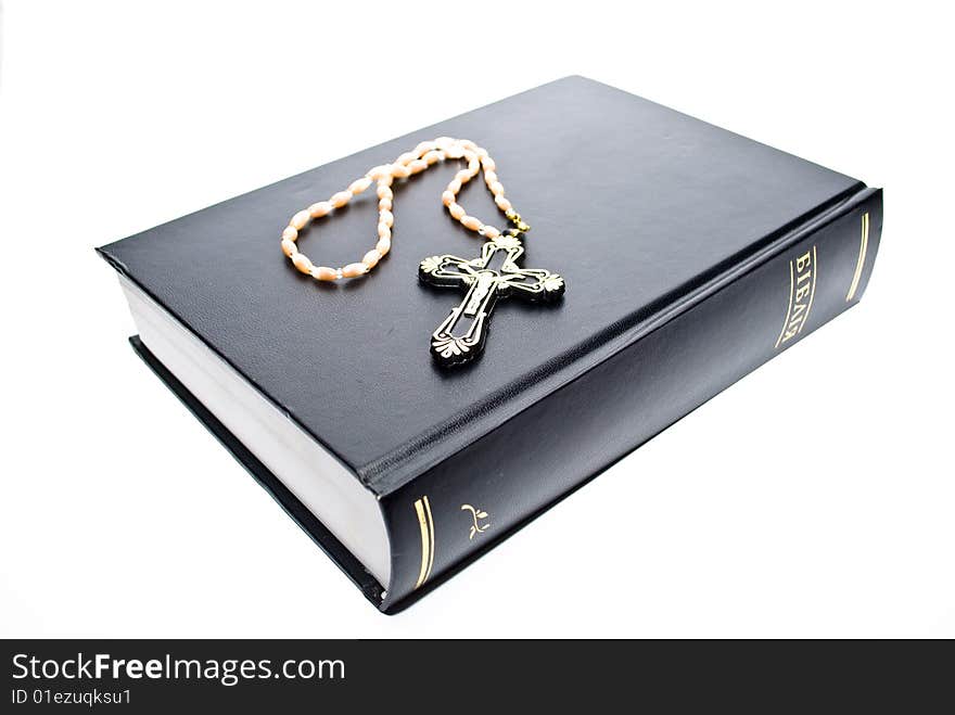 Book and cross on the white background