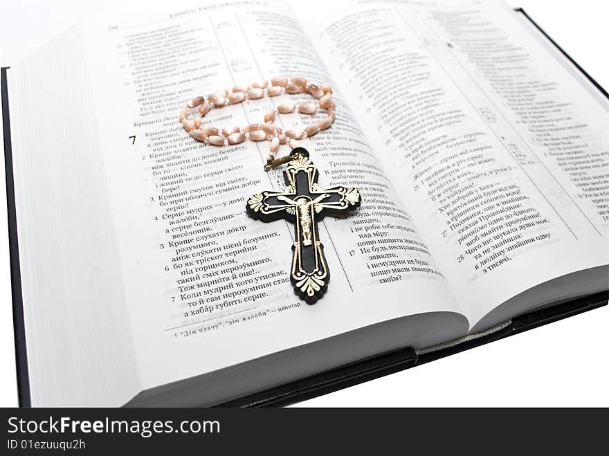 Book and cross on the white background