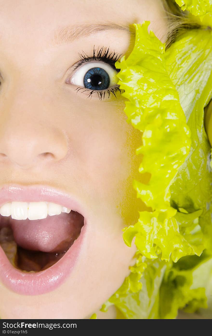 Portrait of pretty woman in astonishment in salad leafs. Portrait of pretty woman in astonishment in salad leafs.