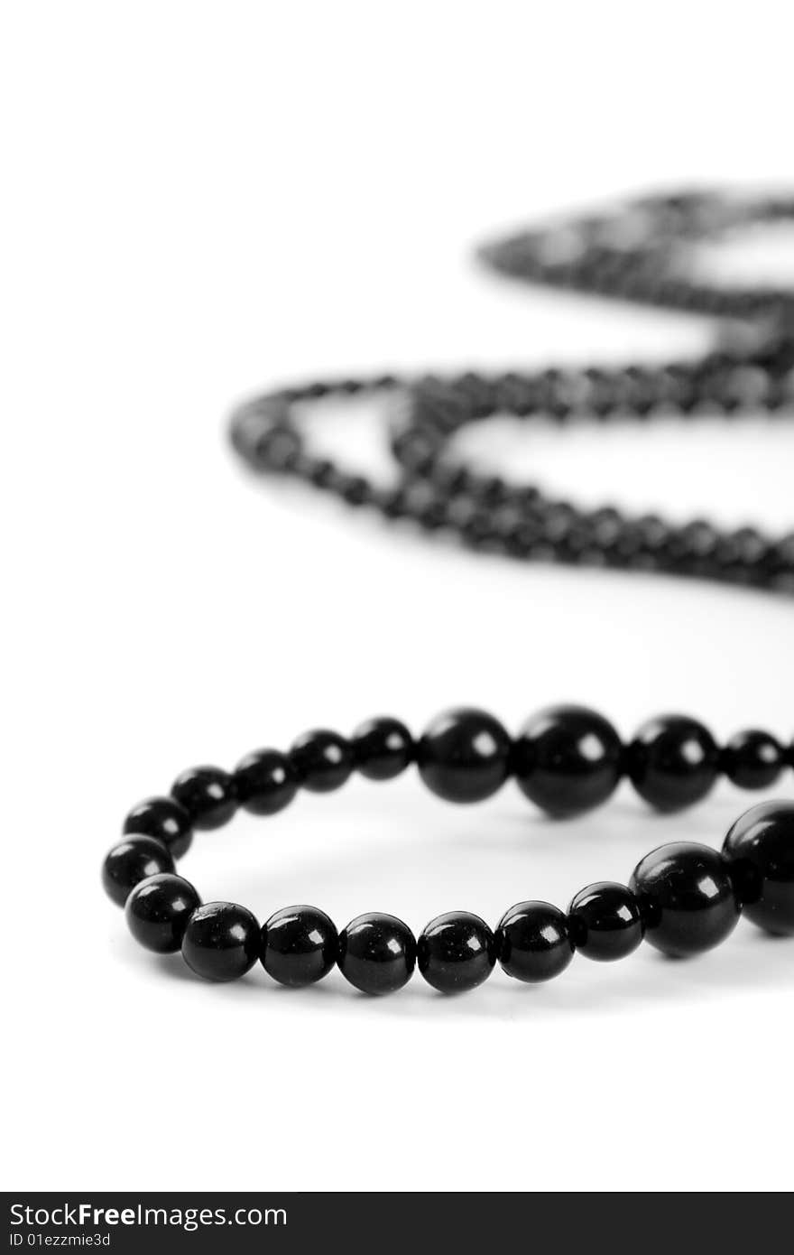 Black necklace on a white background