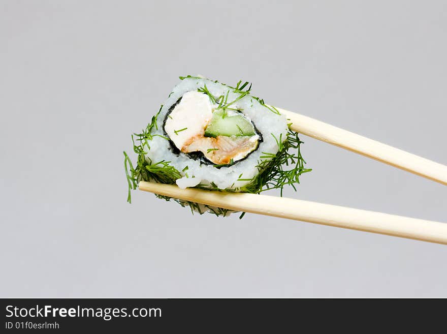 Sushi and chopsticks on the neutral background