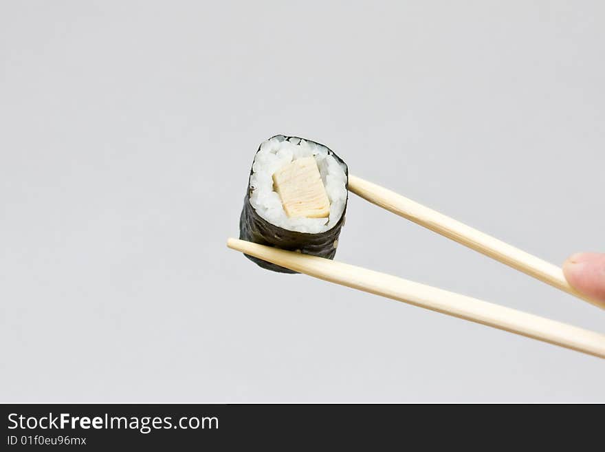 Sushi and chopsticks on the neutral background