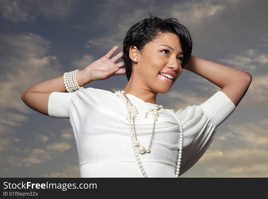 Young model posing on a dark blue sky. Young model posing on a dark blue sky