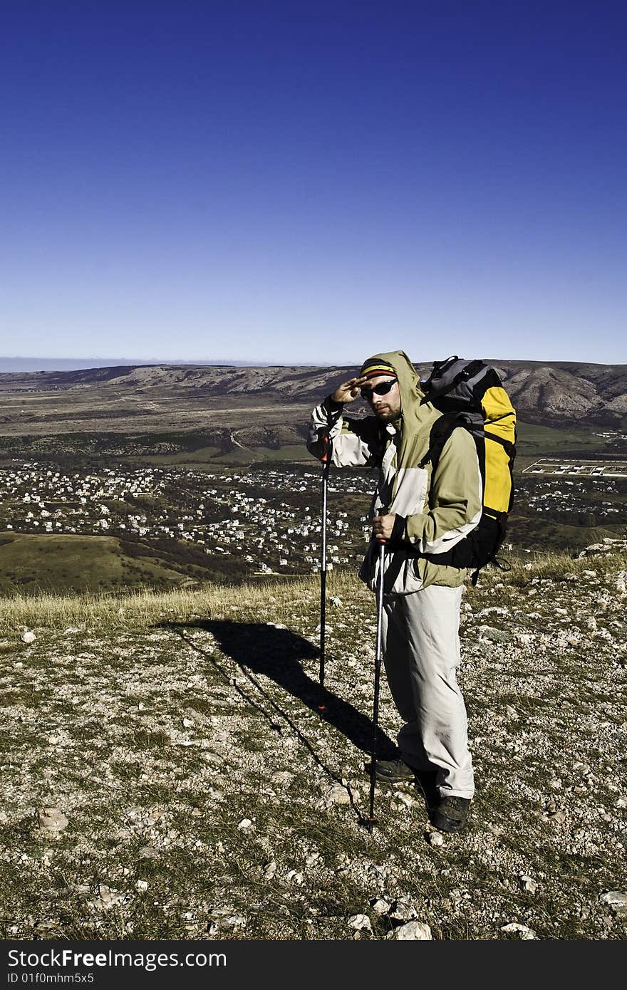 Hiker on the summit looking ahead