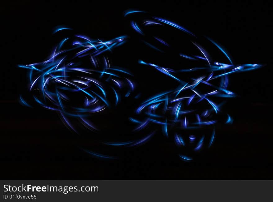 Streaming neon light shapes in the dark. Streaming neon light shapes in the dark