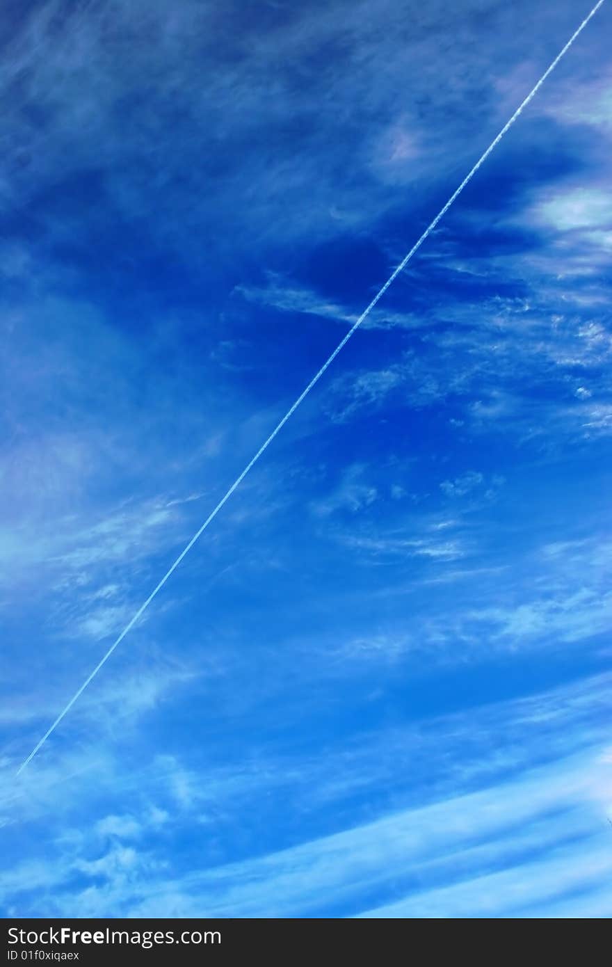 Beautiful clouds and sky with flying airplane jet