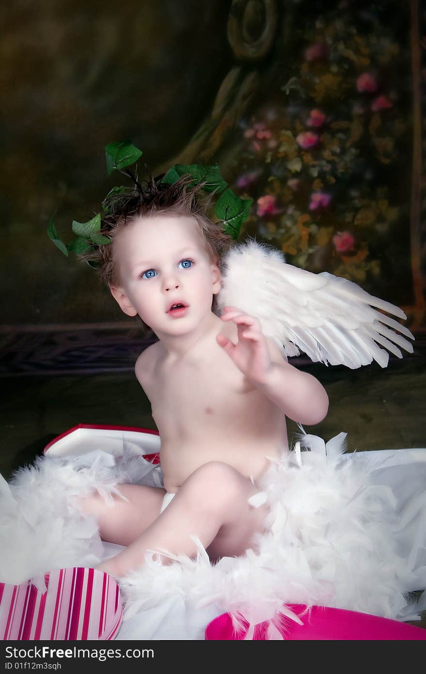 Little Blue Eyed Boy with wings, surrounded by hearts. Little Blue Eyed Boy with wings, surrounded by hearts