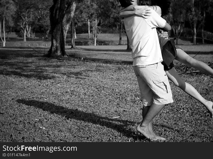 A loving couple enjoying intimate moments in the outdoor. A loving couple enjoying intimate moments in the outdoor