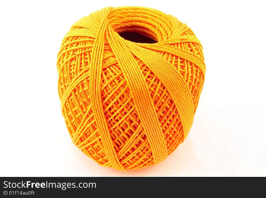 Orange wool clew on white background