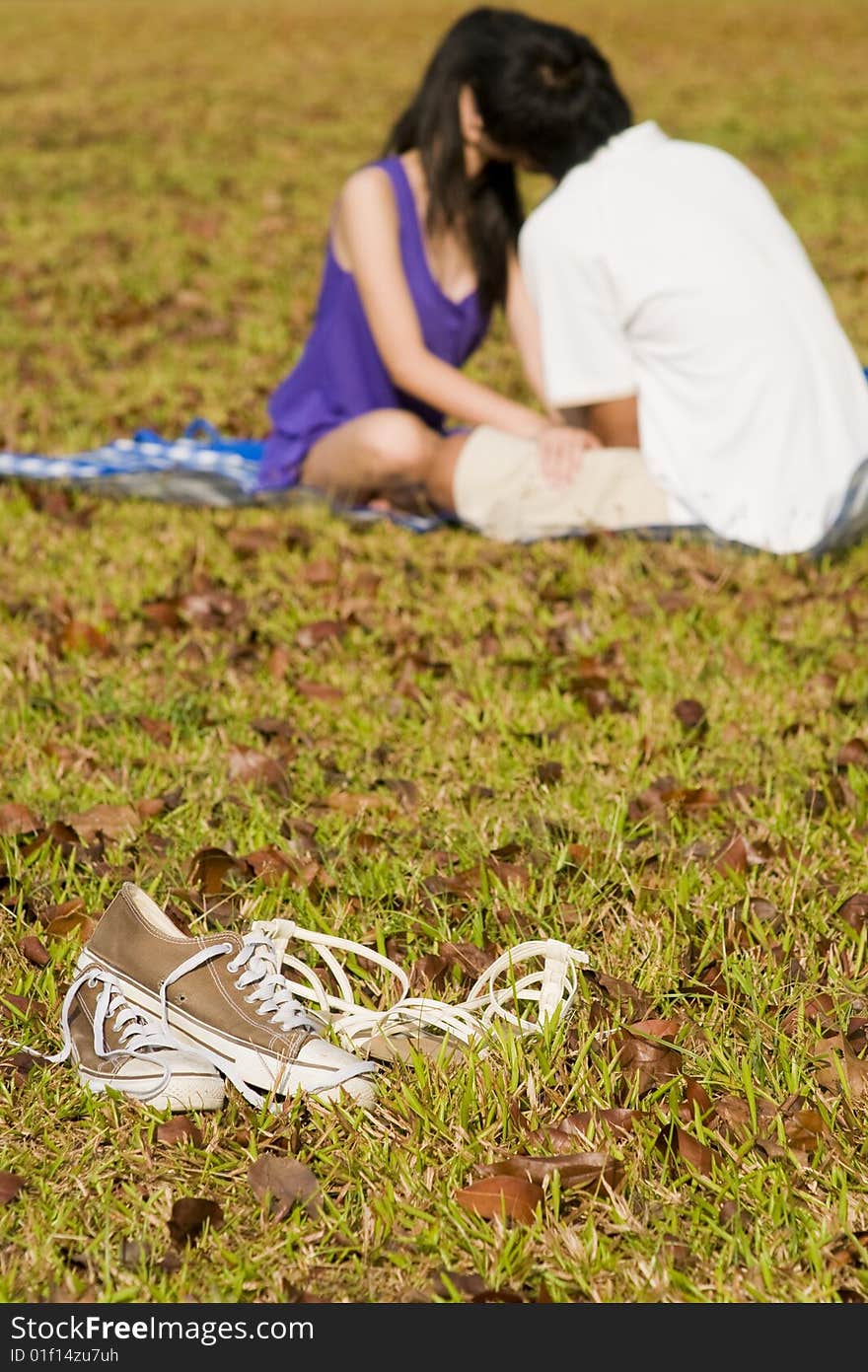 A loving couple enjoying intimate moments in the outdoor. A loving couple enjoying intimate moments in the outdoor