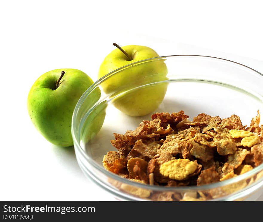 Delicious muesli in a glanse dish with two apple isolated