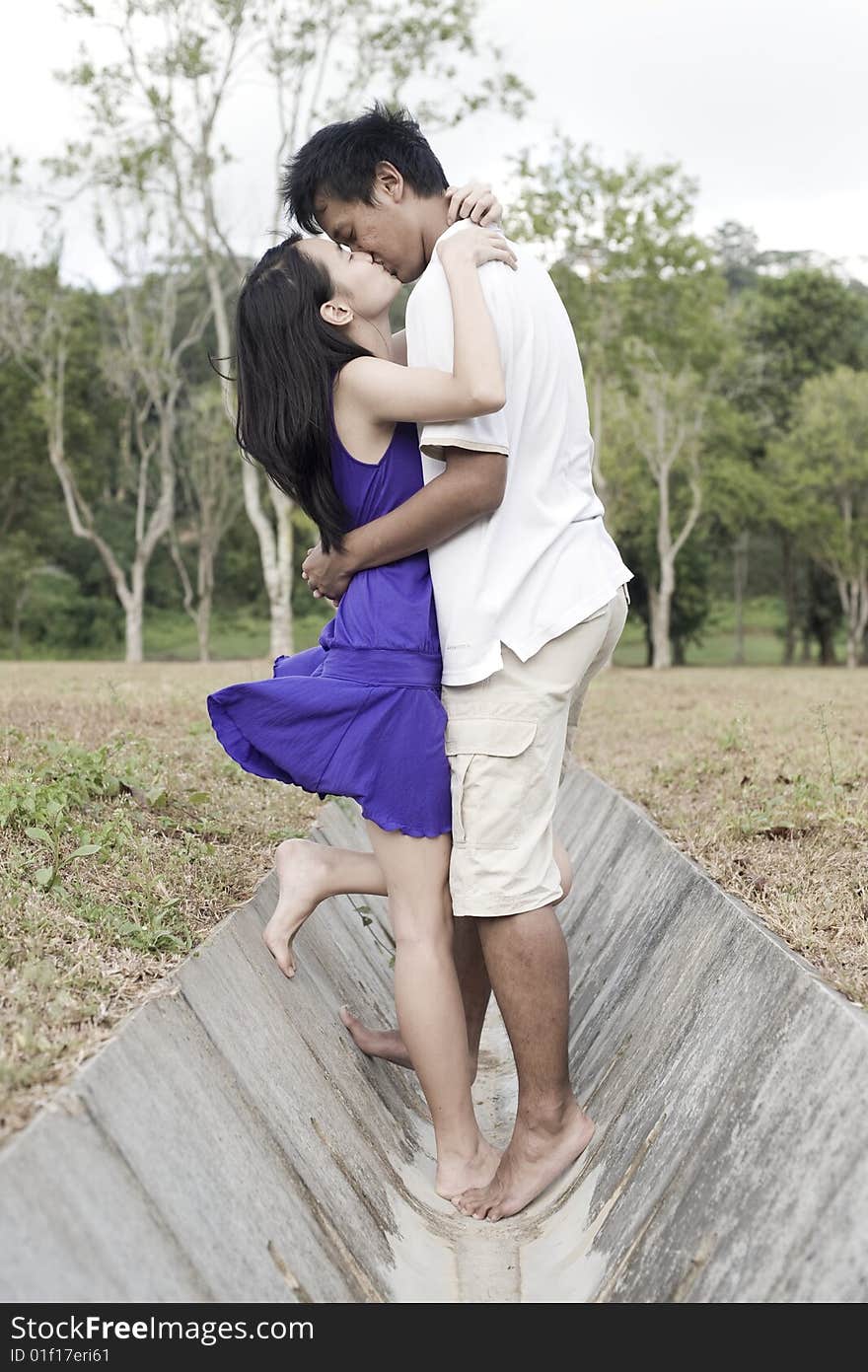 A loving couple enjoying intimate moments in the outdoor. A loving couple enjoying intimate moments in the outdoor