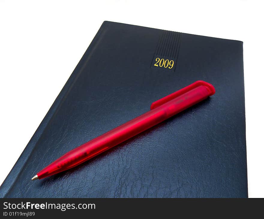 Notebook with a pen resting on it