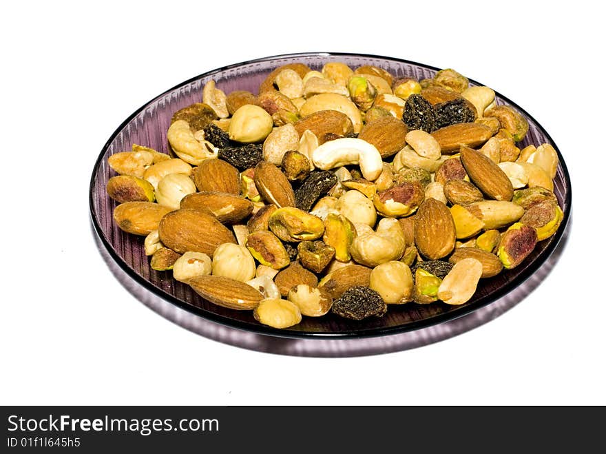 Plate with roasted nuts isolated on white. Plate with roasted nuts isolated on white