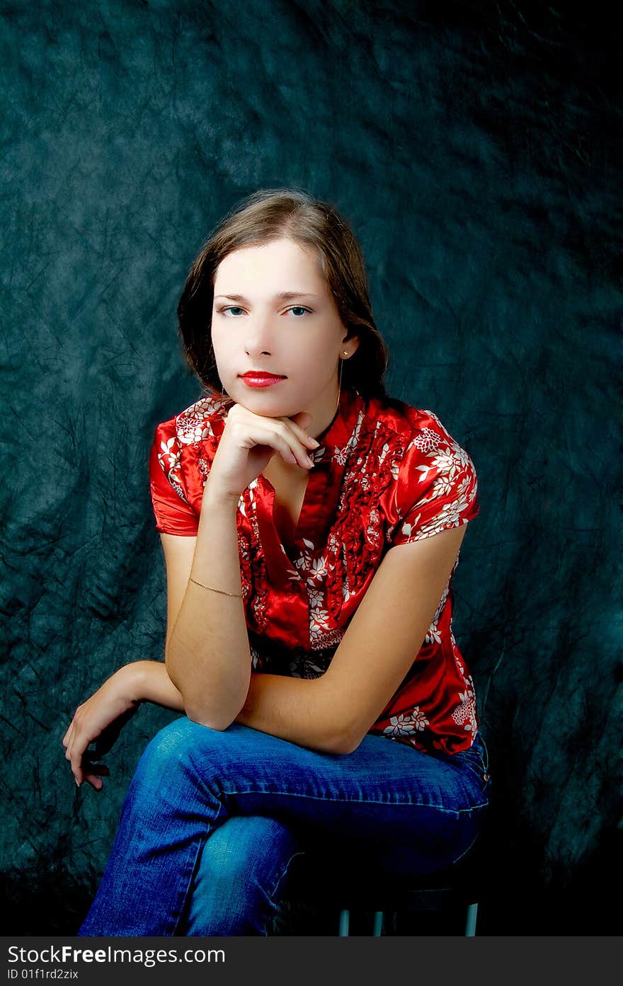 Pretty girl sitting on chair thinking